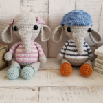 crochet elephants sitting next to some books