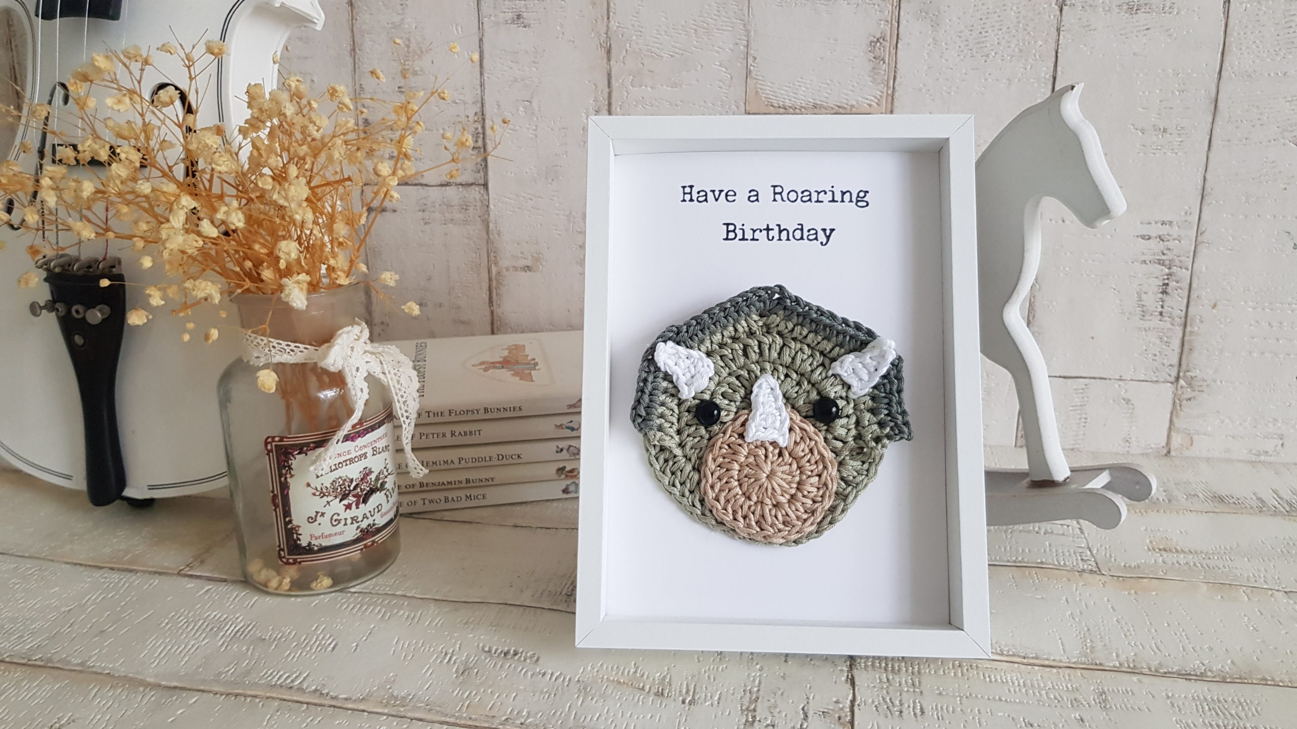 crochet dinosaur card in picture frame