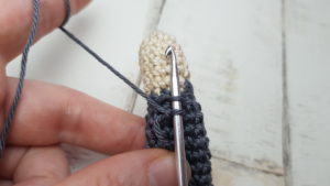 connecting yarn to the arm to make frill