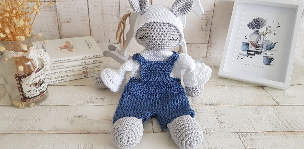 crochet bunny lovey sitting next to a picture