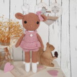 crochet deer standing next to a wooden squirrel