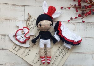 pierrot doll on a music sheet with her skirts and scarf