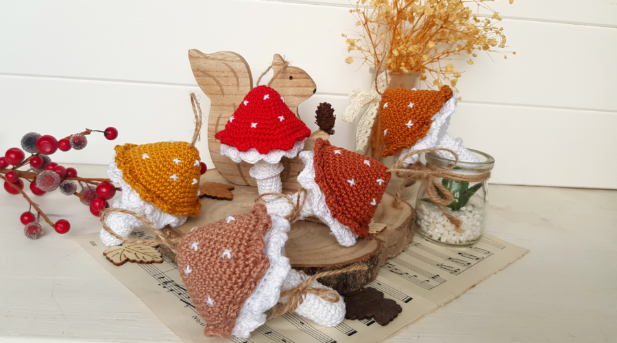 five crochet mushrooms with different colours